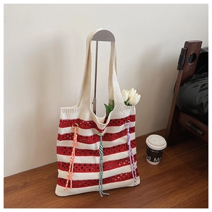 Detail of red and white striped knit tote bag with colorful decorative braided cords