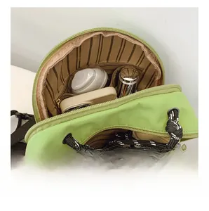 Detail view of the light green bag interior showing storage capacity for daily essentials