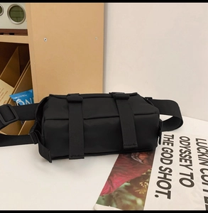 Detail of durable black nylon messenger bag with adjustable buckles and wide shoulder strap
