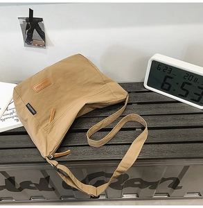 Detail of khaki water-repellent nylon crossbody bag with CHUANGMI leather label