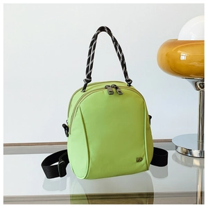 Top view of avocado green nylon multi-way backpack with silver logo and woven handle