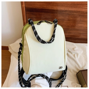 Detail of white and green crossbody backpack with thick woven nylon rope handle and logo