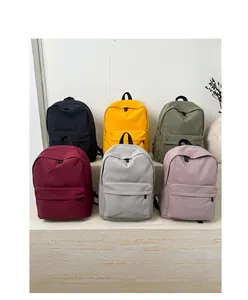 Detailed display of minimalist canvas backpacks in six colors with front zipper pocket