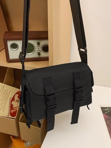 Minimalist black nylon messenger bag with double buckle closure for men and women