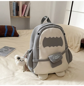 Detail eines Hai-Rucksacks mit süßem Wolkenanhänger und Marken-Fronttasche