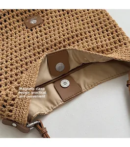 Detail of hand-woven straw tote bag with magnetic closure and leather brand label