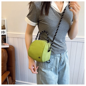Fluorescent green nylon crossbody bag with black and white woven rope handle and strap