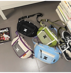 Flat lay of four nylon crossbody chest bags in black, green, beige, and blue with mesh detail