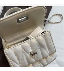 Detail view of the mini chain bag interior featuring a functional pocket and storage space