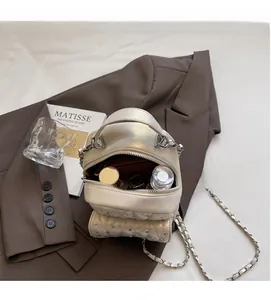 Quilted cream backpack interior showing storage space for makeup and daily essentials