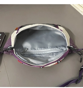 Detail view of the multi-compartment interior with gray lining and zip pocket on crossbody bag
