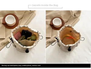 Detail of off-white drawstring bucket bag showing high capacity storage for daily essentials