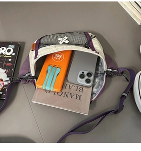 Detail showing high-capacity interior of beige and purple crossbody bag with daily items