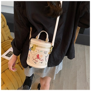 Detail view of graffiti barrel bag with colorful hand-drawn patterns and dual zippers