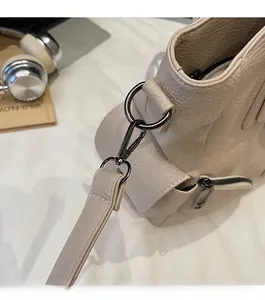 Détail du fermoir mousqueton gris foncé sur le sac cabas en cuir grainé beige