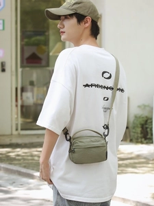 Olive green crinkled nylon mini crossbody bag with black plastic hook and fabric strap