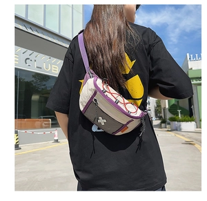 Outdoor street view of a beige and purple crossbody bag worn by a model in urban style