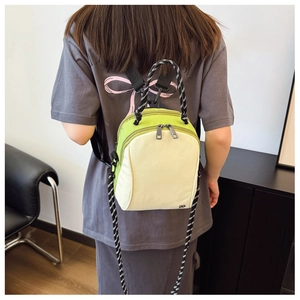 Detailed back view of a compact two-tone nylon shell bag with woven shoulder straps