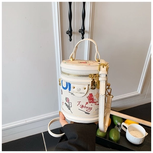 Detail view of white graffiti bucket bag with colorful art prints and gold zipper hardware