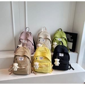 Matrix view of colorful nylon backpacks in purple, beige, green, khaki, yellow and black