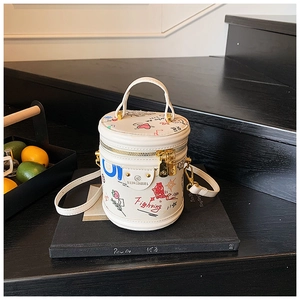 Detail of white graffiti bucket bag with colorful illustrations and detachable shoulder strap