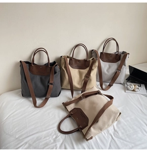 Detailed close-up showing four minimalist canvas tote bags with brown leather corners and straps
