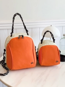 Orange and cream canvas backpack set with stylish woven rope handles and metal accents