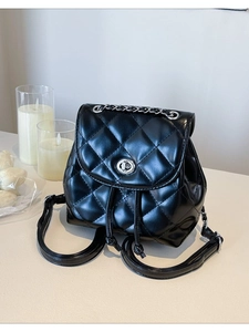 Fashionable black quilted leather backpack with silver chain handle and swivel lock closure