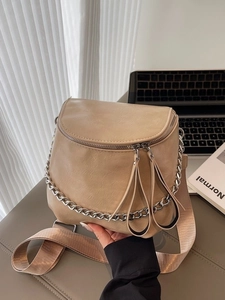 Beige saddle cross body bag with dual zippers and chunky silver chain strap
