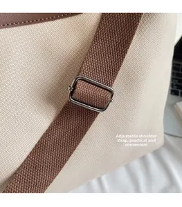 Detail of adjustable shoulder strap with silver metal buckle on canvas tote bag