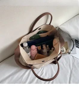 Detailed interior of a large canvas tote bag showing spacious compartments and pockets
