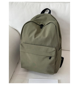 Detailed view of olive green waterproof nylon backpack with front pocket and side compartments