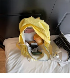 Internal view of a spacious yellow backpack showing compartments for laptop and daily items