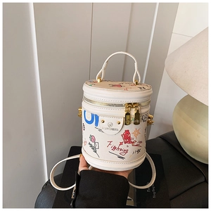 Detail of white graffiti bucket bag with Fighting text and golden hardware accents