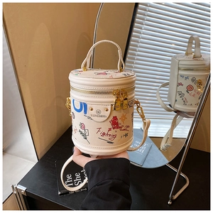 Close-up of doodle bucket bag showing colorful hand-drawn prints and gold chain strap