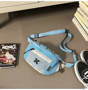 Flat lay of nylon blue and beige crossbody bag with white mesh pocket and wide strap