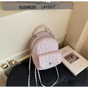 Detail of light pink quilted leather mini backpack with sparkling rhinestones and chain strap