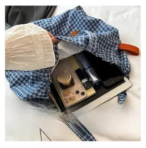 Interior view showing the large storage capacity of this plaid drawstring tote bag