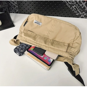 Detail view of khaki nylon crossbody bag showing large capacity for tablet and daily items