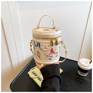 Detail of trendy graffiti bucket bag with colorful sketches and metal brand plaque