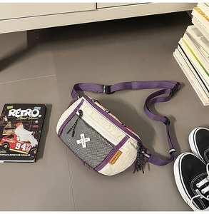 Close-up of purple and cream nylon crossbody bag with black mesh pocket and logo strap