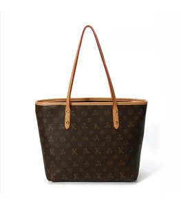 Close-up of brown tote bag with K-pattern monogram and gold-tone metal brand nameplate