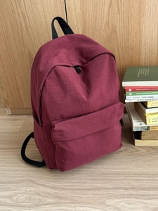 Minimalist burgundy high-capacity backpack for students with sleek canvas texture