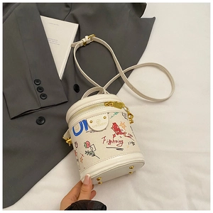 Detailed macro view of graffiti leather bucket bag base with protective metal feet