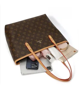 Top view of large tote bag showing spacious interior with tablet, phone, and cosmetics