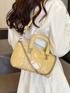 Quilted faux leather yellow crossbody bag with silver chain and chic diamond stitching
