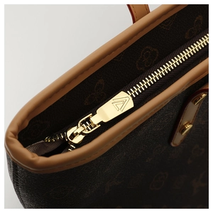 Detailed close-up of dark brown monogram tote bag with high-quality gold metal zipper