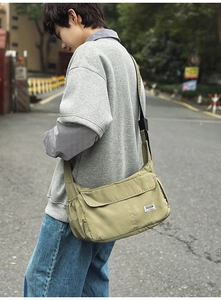 Detailed view of durable khaki nylon crossbody bag with side pocket and front flap