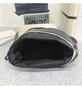 Close-up of the large main compartment interior of this stylish nylon crossbody bag