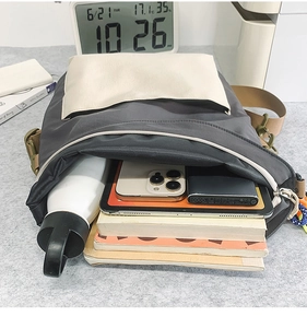 Interior view showing the large capacity of the nylon crossbody bag with daily essentials